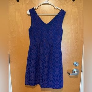 Purple/periwinkle cocktail dress with patterned stitching.
